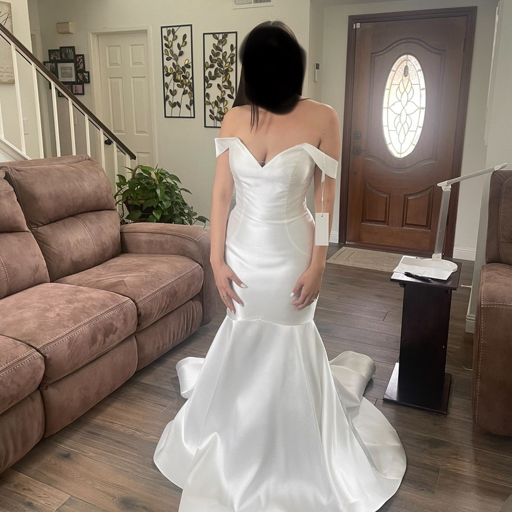Wedding dress. Never worn, got pregnant.